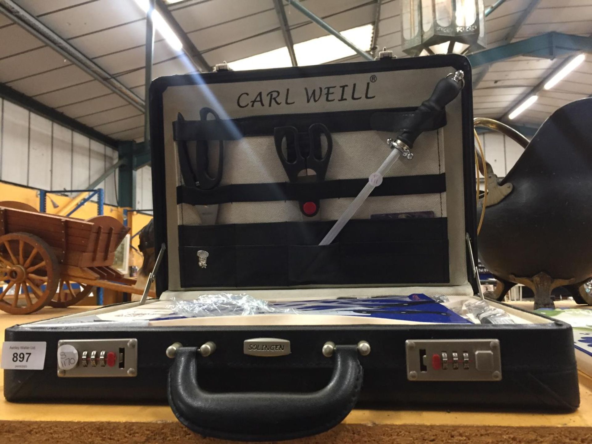 A CARL WEILL KNIFE SET IN A COMBINATION CASE