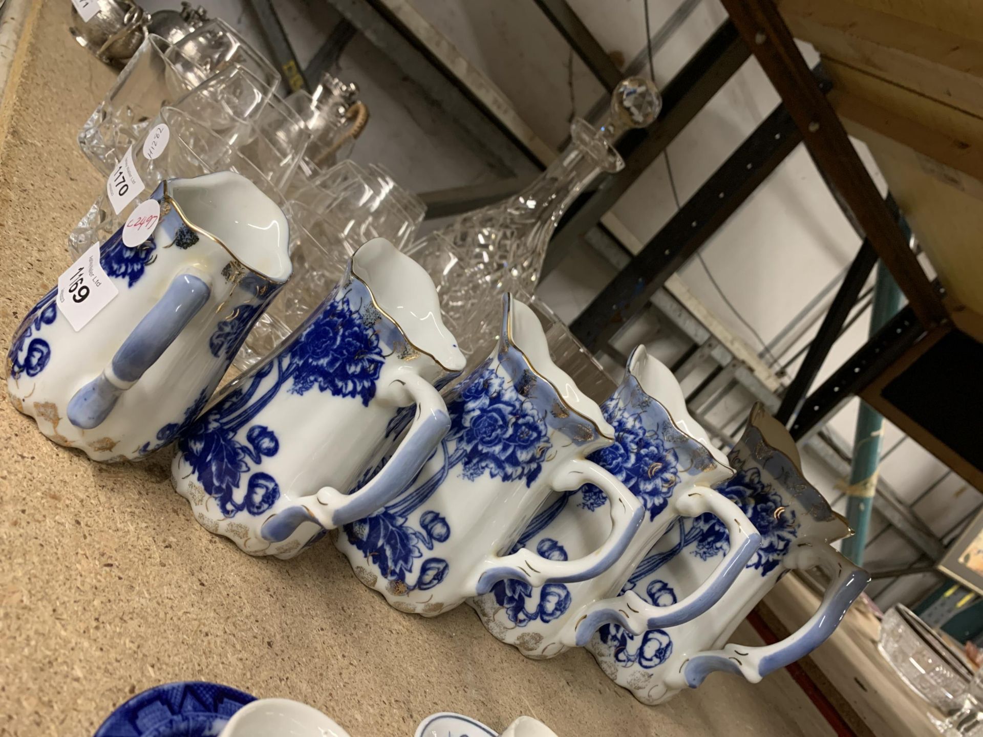 A SET OF FIVE VINTAGE GRADUATED BLUE AND WHITE JUGS