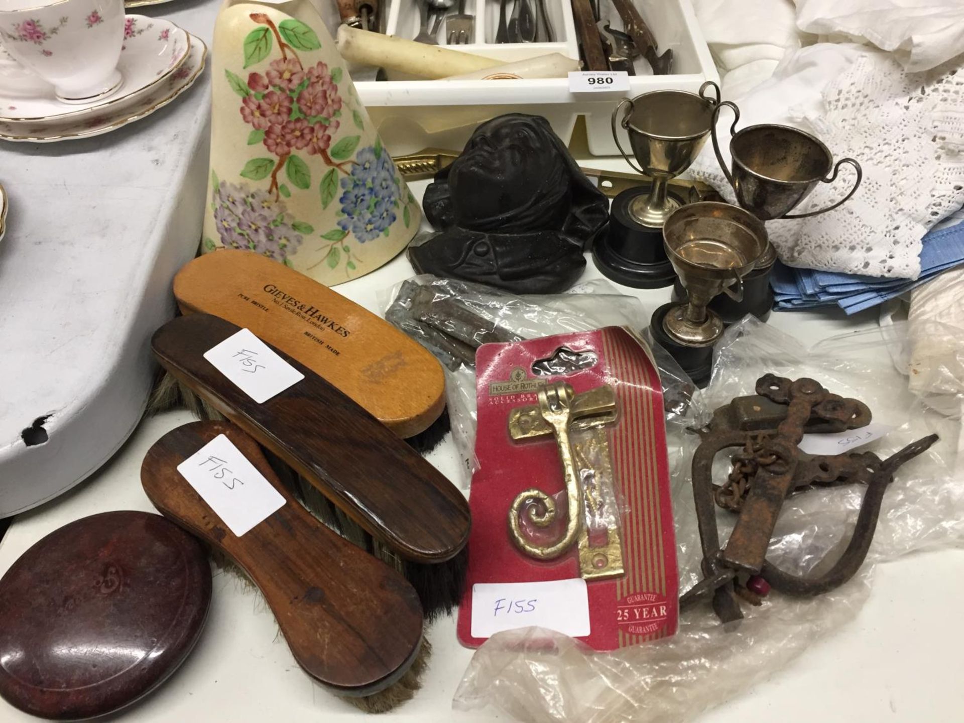 A MIXED LOT TO INCLUDE SMALL SILVER PLATED TROPHIES, WINDOW FURNITURE, TWO WALL POCKETS, ETC