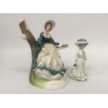 A FINE BONE CHINA FIGURE OF A LADY SITTING IN A BRANCH "EMILY" TOGETHER WITH A SMALL PORCELAIN LADY