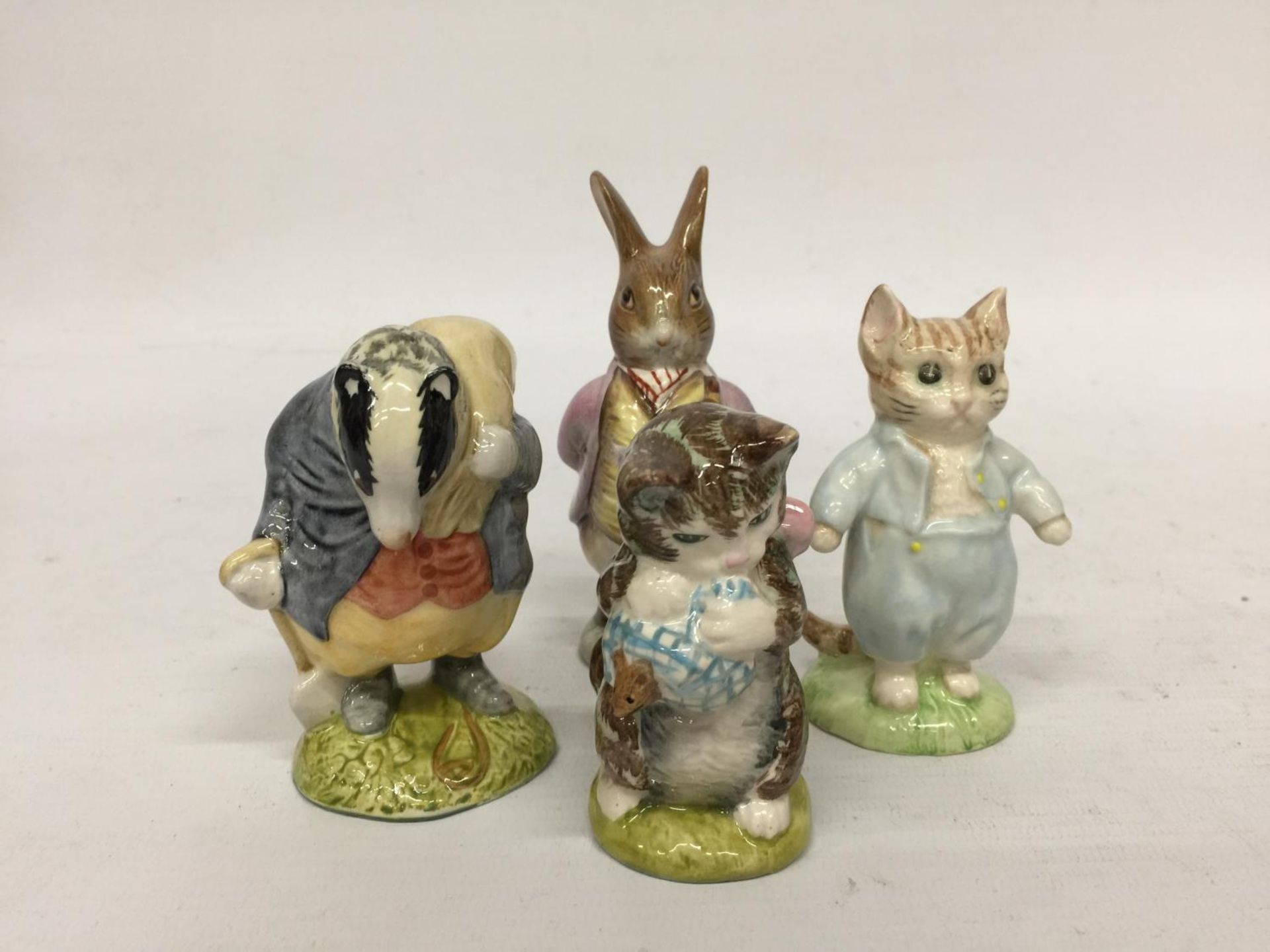 FOUR ROYAL ALBERT BEATRIX POTTER FIGURES TO INCLUDE TOMMY BROCK, TOM KITTEN, BENJAMIN BUNNY AND MISS