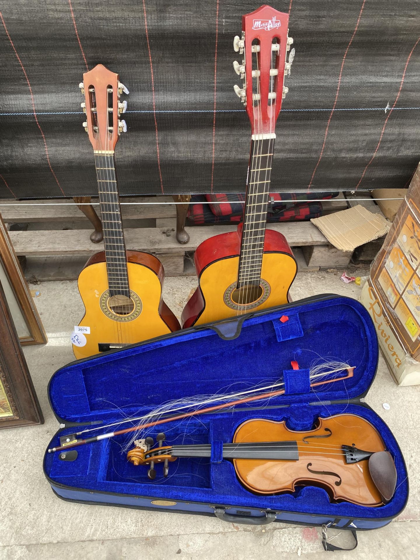 TWO CHILDS ACOUSTIC GUITARS AND A CASED VIOLIN