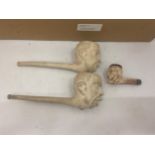 A PAIR OF VINTAGE CLAY MEERSCHAUM FIGURAL PIPES AND SMALLER EXAMPLE