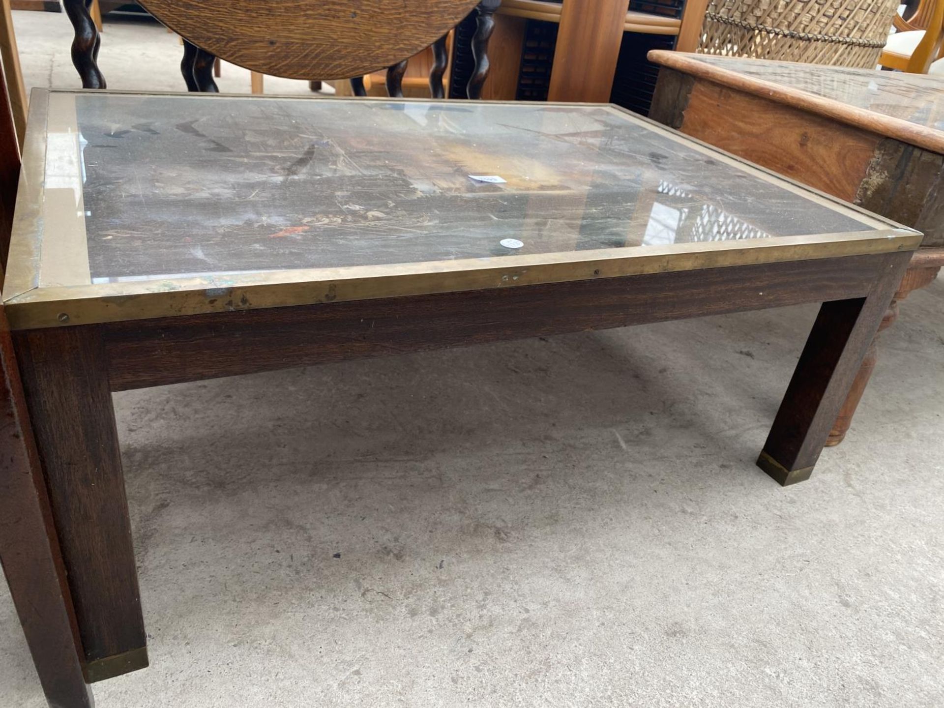 A MODERN COFFEE TABLE WITH BRASS TRIM, THE TOP DEPICTING MASTED BATTLESHIPS, 35X24" - Image 4 of 4