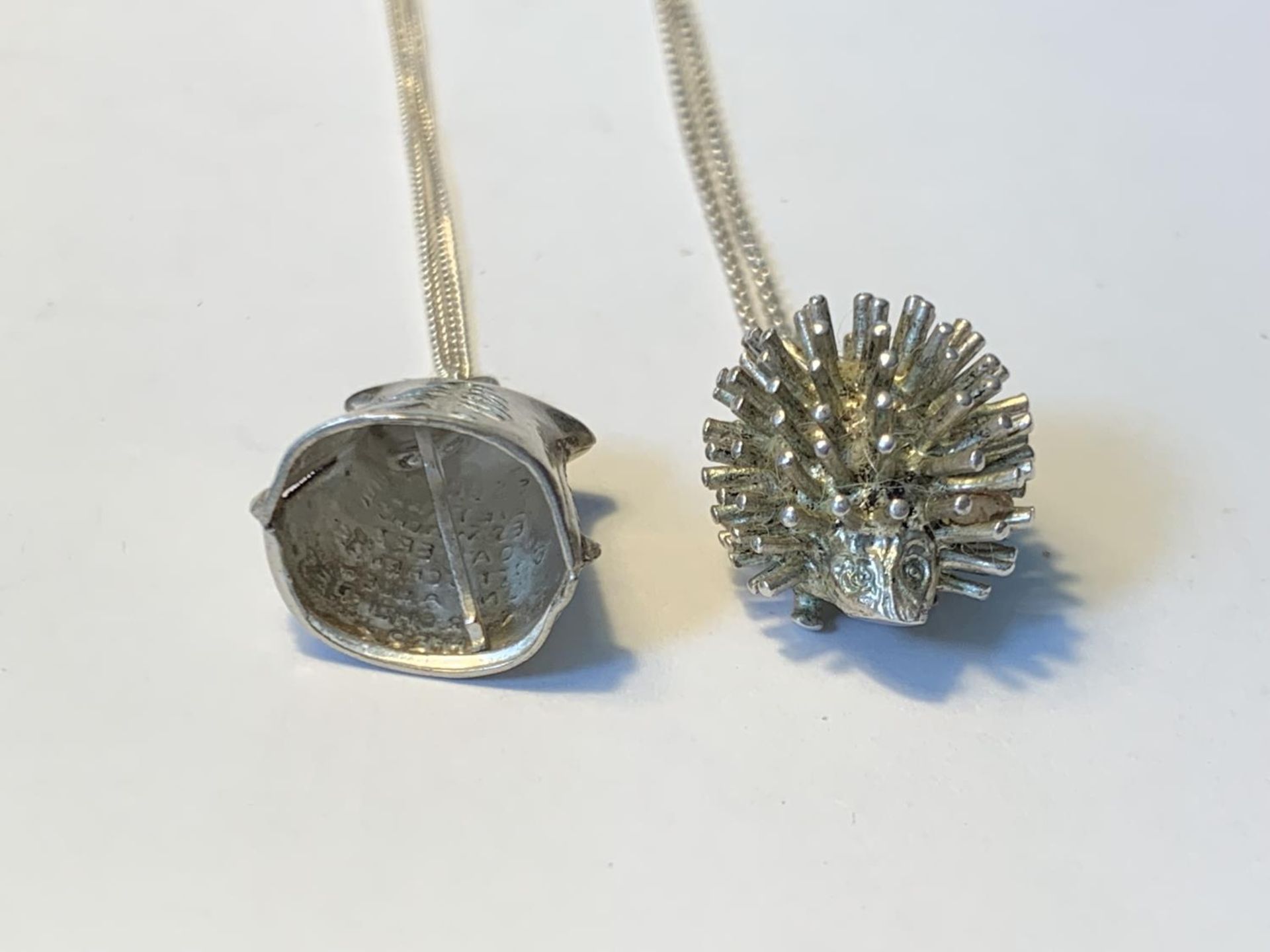 TWO SILVER NECLACES WITH PENDANTS TO INCLUDE A HEDGEHOG AND A BELL - Image 3 of 3