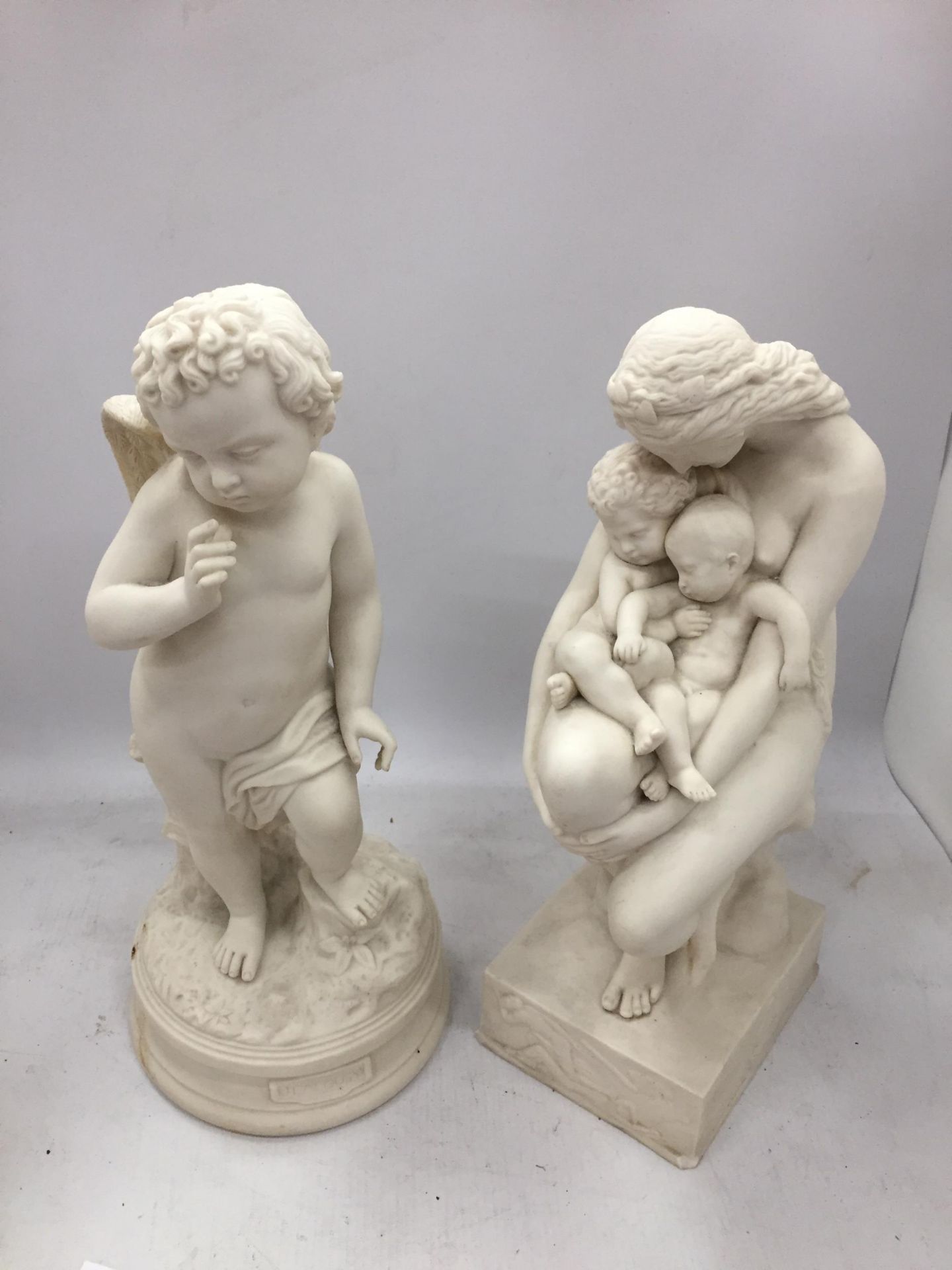 TWO PARIAN WARE FIGURES, ONE OF A MOTHER HOLDING CHILDREN AND THE OTHER TITLED 'JEALOUSY'