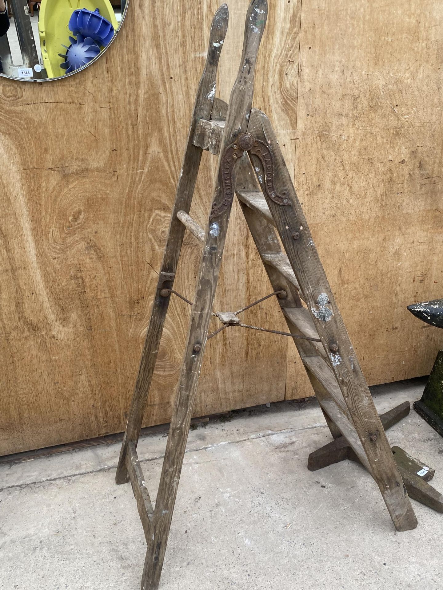 A VINTAGE FIVE RUNG WOODEN STEP LADDER WITH METAL HINGES BEARING THE NAME 'SIMPLEX'