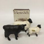 A BESWICK ABERDEEN ANGUS CALF TOGETHER WITH A BLACK FACED RAM AND BLACK FACED SHEEP
