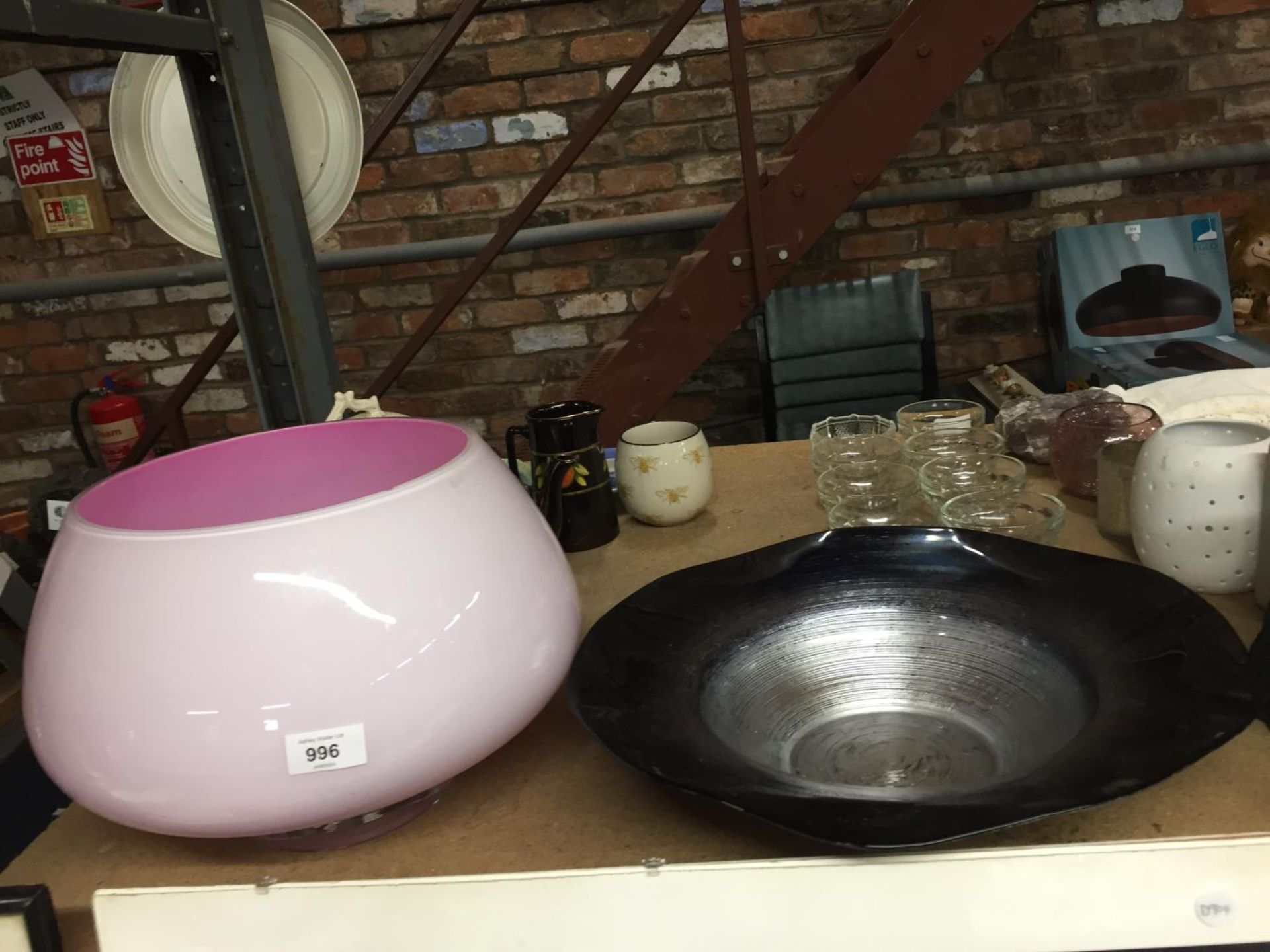 A LARGE PINK GLASS BOWL PLUS A LARGE BLACK AND SILVER BOWL