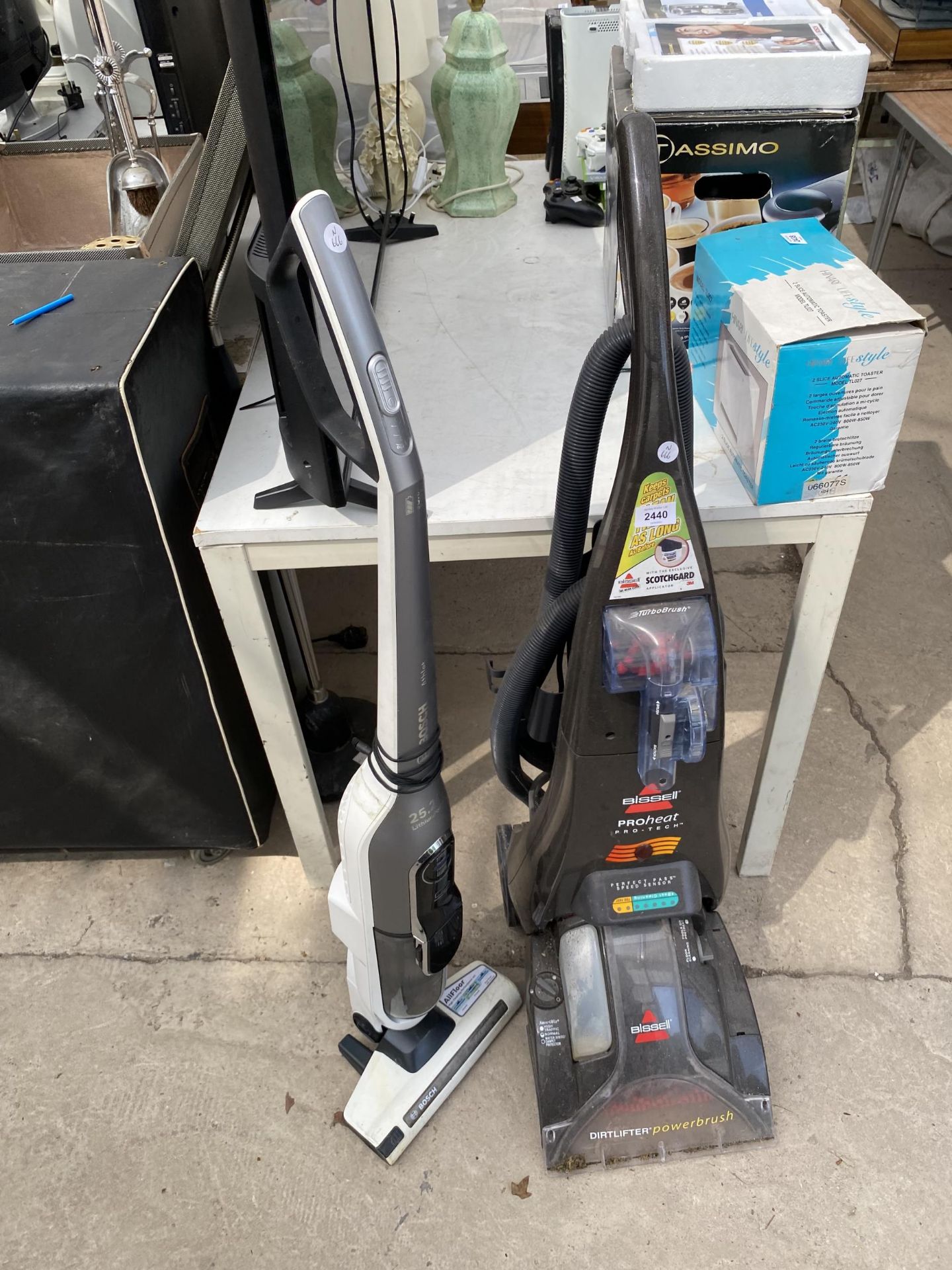 A BISSELL CARPET CLEANER AND A BOSCH STICK VACUUM