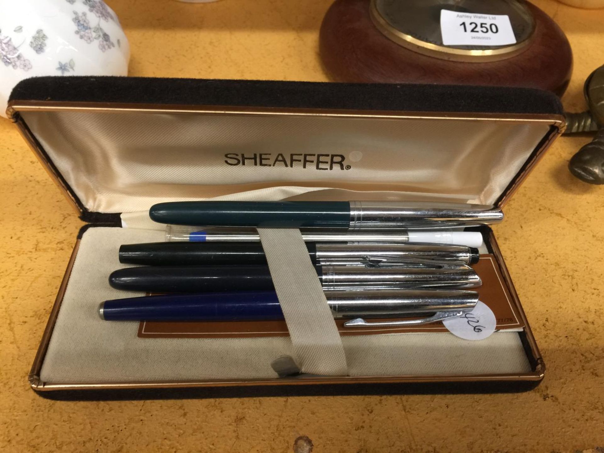 A SHEAFFER BOX TOGETHER WITH A VARIETY OF PENS