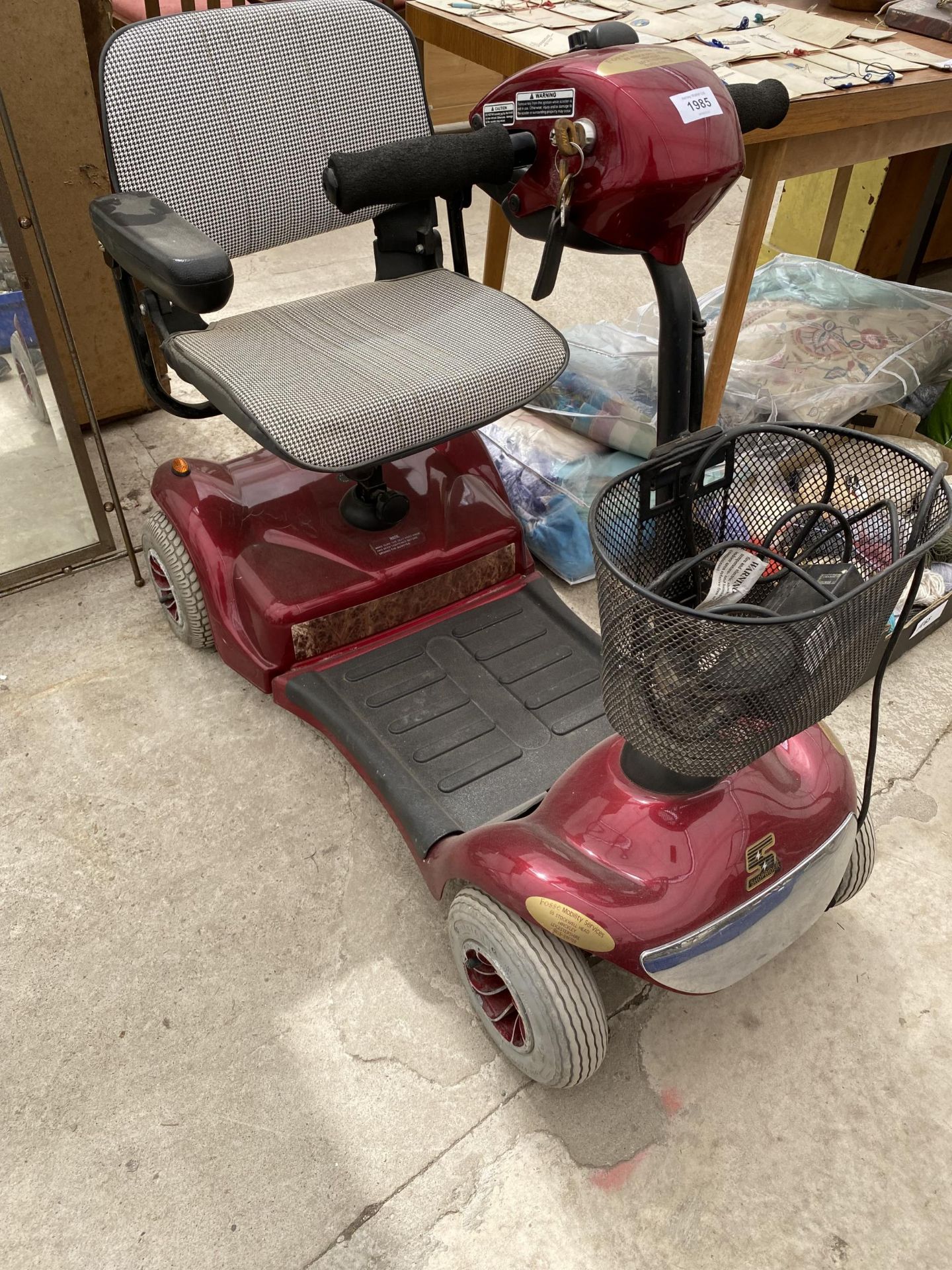 A SHOPRIDER DELUXE MOBILITY SCOOTER WITH KEY AND CHARGER