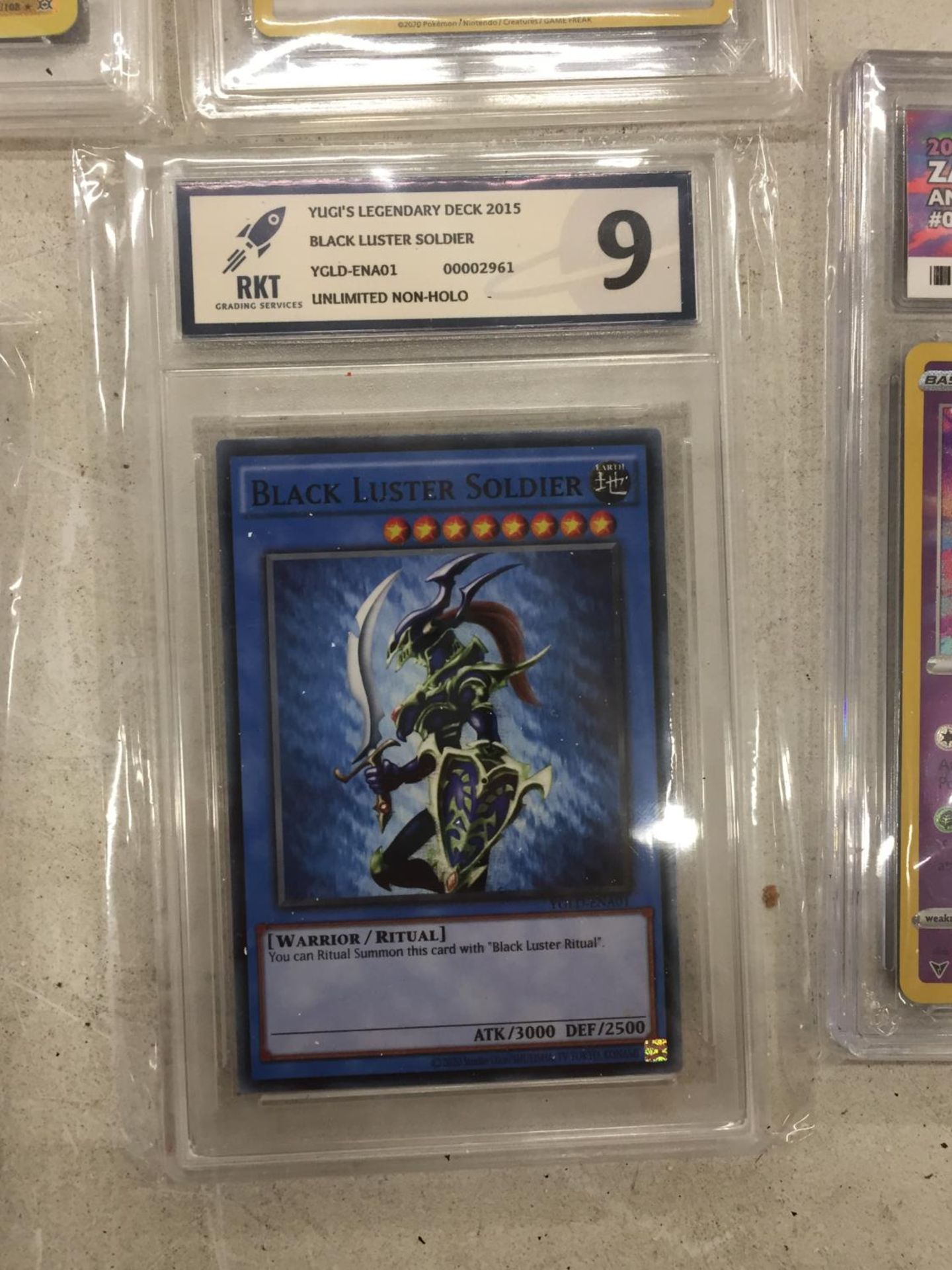 A YU-GI-OH GRADE 9/10 'BLACK LUSTER SOLDIER' TRADING CARD