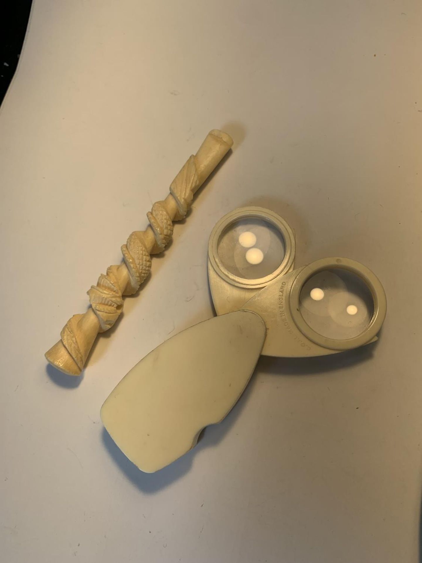 A BONE CHEROOT HOLDER AND MAGNIFYING GLASS