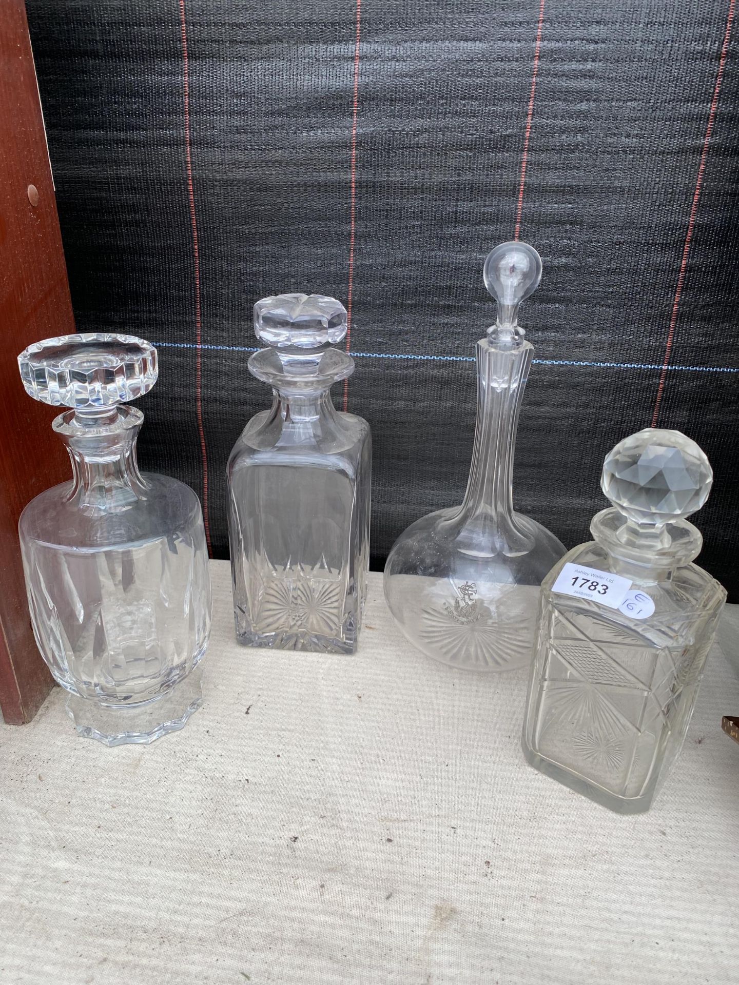 FOUR VINTAGE GLASS DECANTERS
