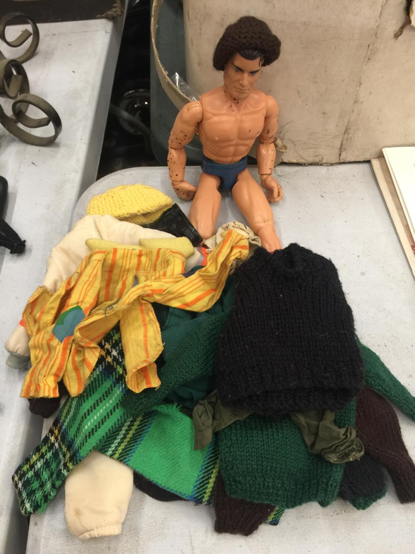 AN ACTION MAN AND A BUNDLE OF CLOTHING, SOME HAND MADE