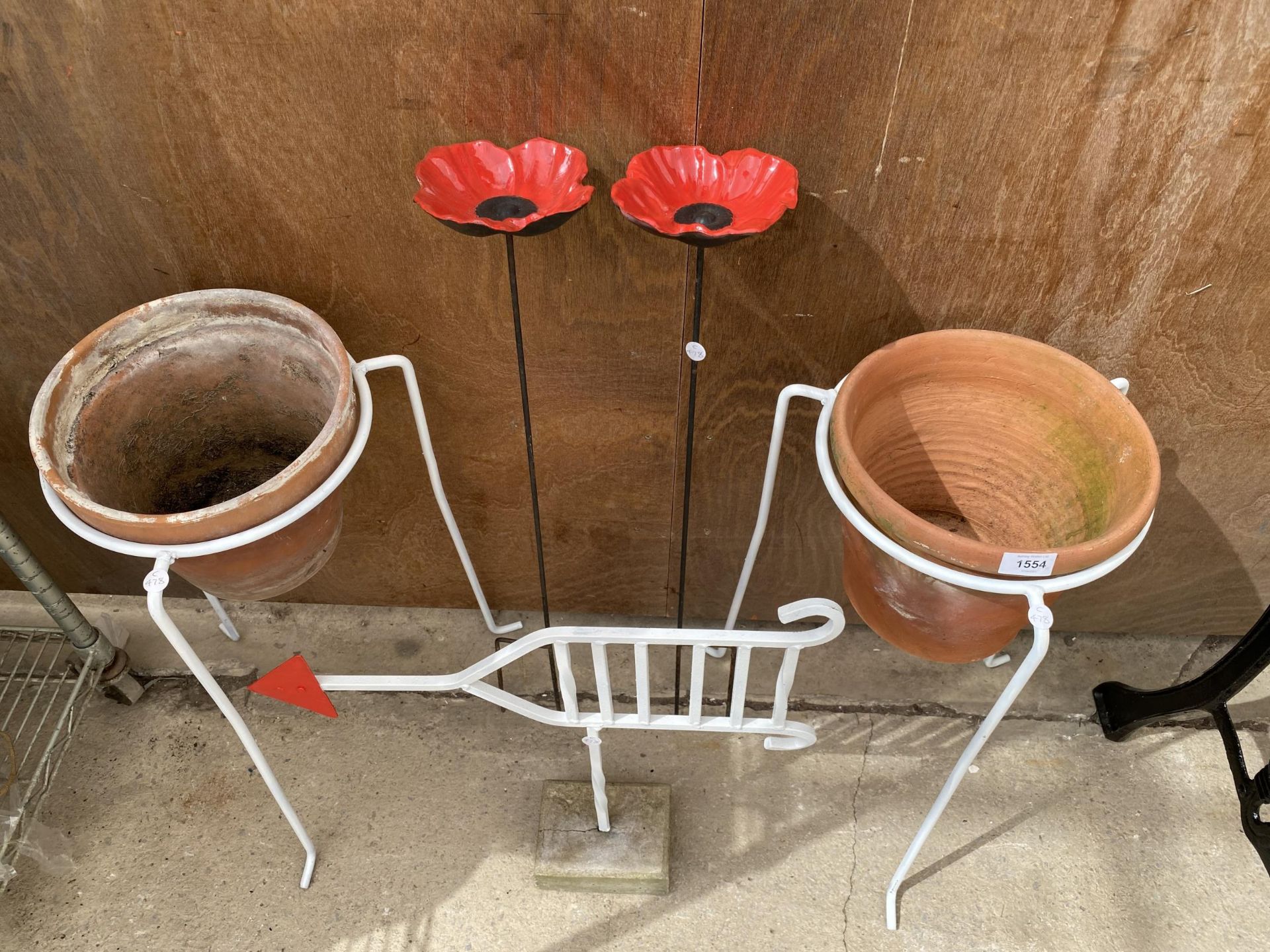 AN ASSORTMENT OF ITEMS TO INCLUDE TWO PLANT POT STANDS, AN ARROW SIGN SET IN CONCERETE AND TWO