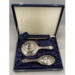 A CASED HALLMARKED SILVER BACKED THREE PIECE DRESSING SET COMPRISING COMB, MIRROR AND BRUSH