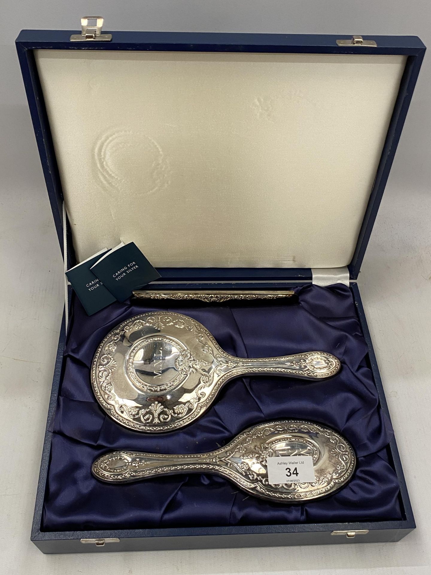 A CASED HALLMARKED SILVER BACKED THREE PIECE DRESSING SET COMPRISING COMB, MIRROR AND BRUSH