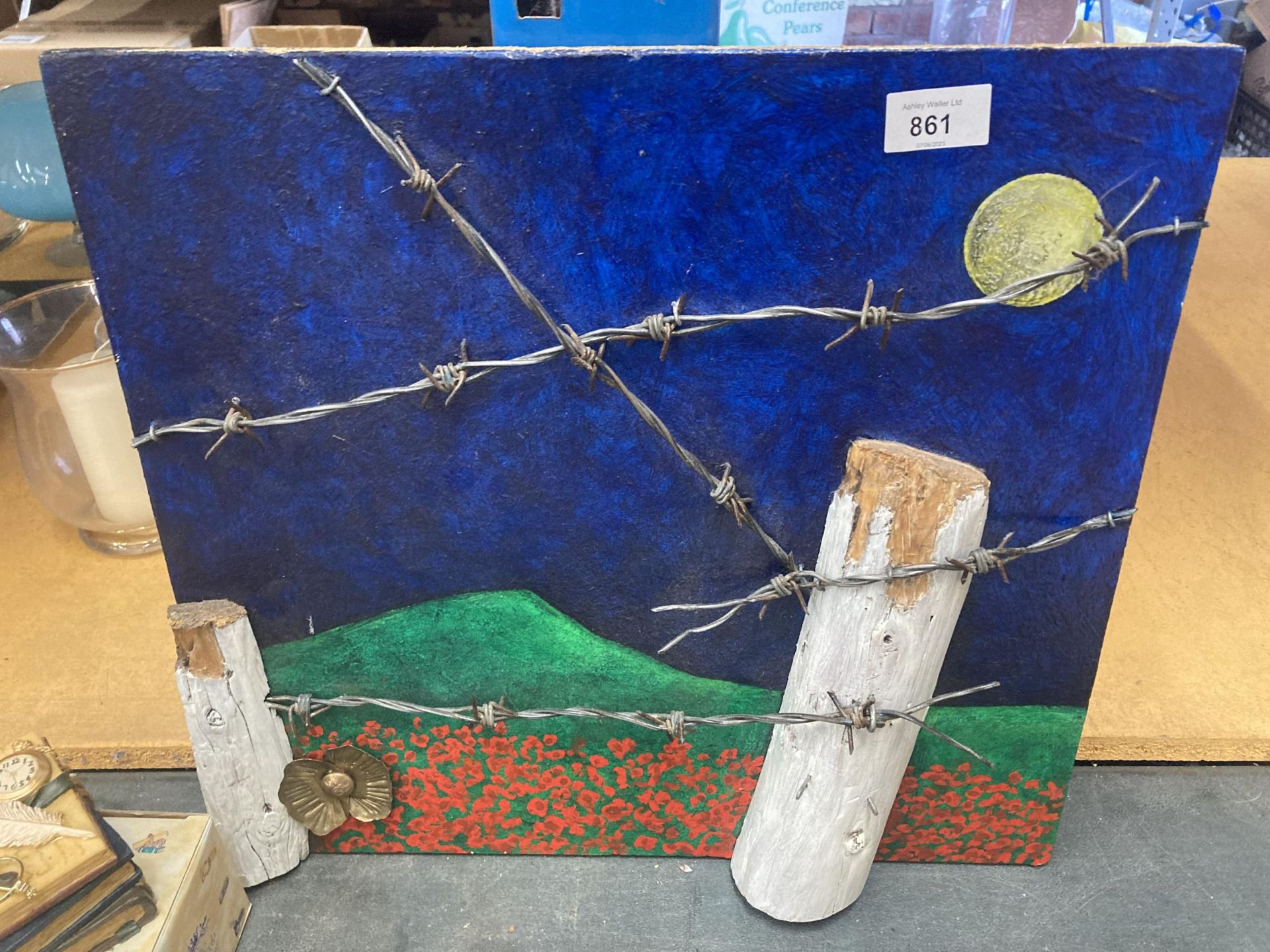 A PAINTING ON BOARD OF A WW1 POPPY FIELD WITH BARBED WIRE. TO THE REVERSE IS A POEM AND THE NAME