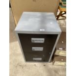 A METAL THREE DRAWER FILING CABINET