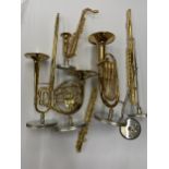 A GROUP OF MINIATURE MUSICAL INSTRUMENTS ON STANDS