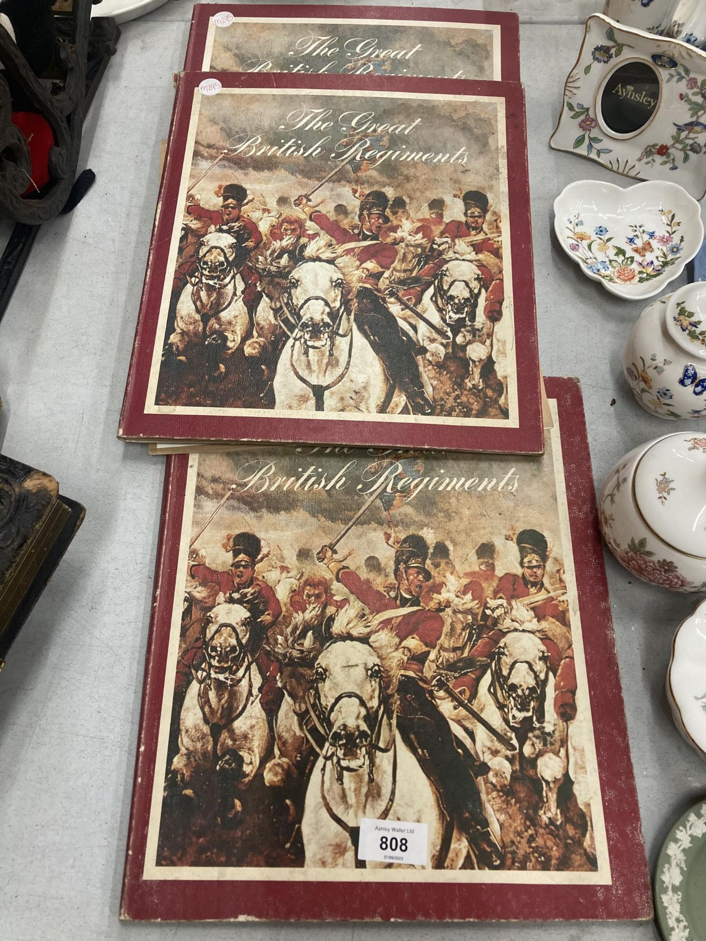 THREE TEXACO FOLDERS CONTAINING BRITISH REGIMENTAL BADGES - NOT COMPLETE