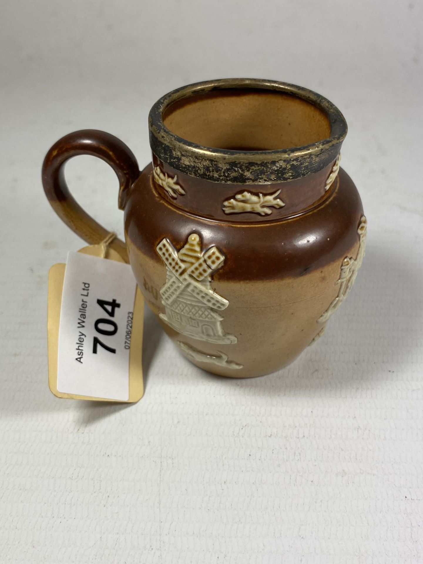 A ROYAL DOULTON LAMBETH SALT GLAZED HUNTING JUG WITH SILVER RIM