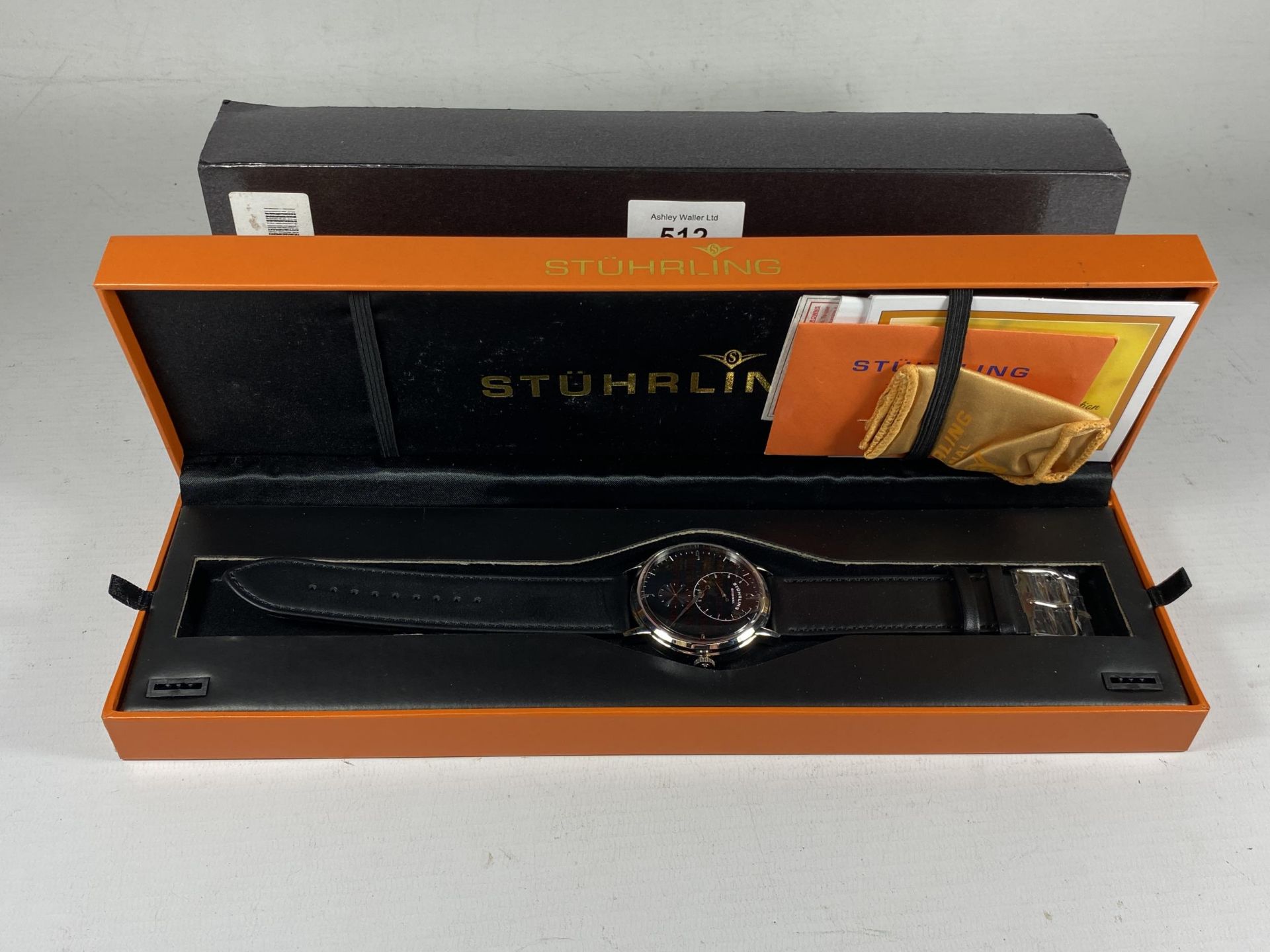 A GENTS BOXED STURHLING WATCHWITH PAPERS, CLOTH ETC