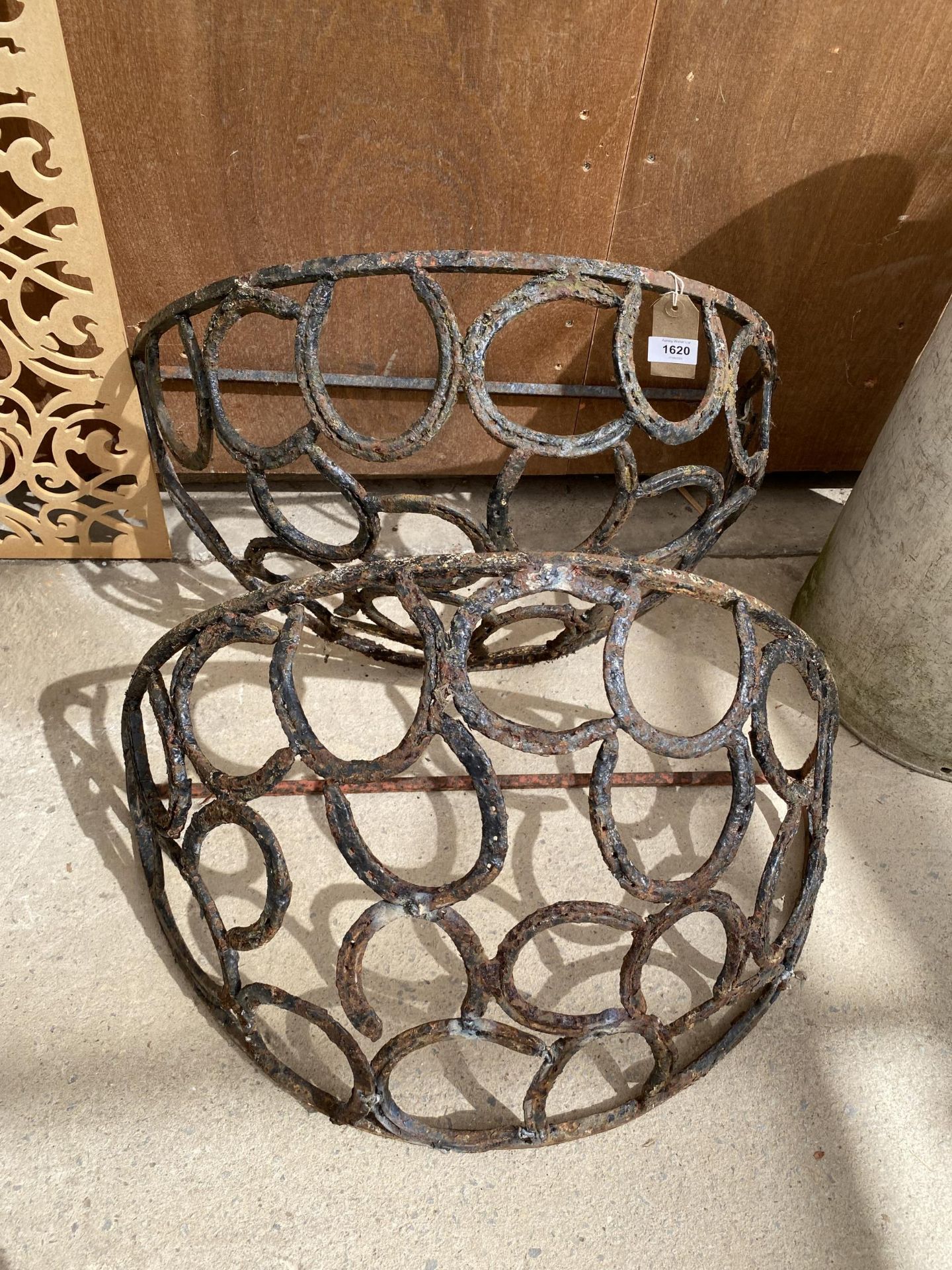 A PAIR OF METAL HORSE SHOE HAY RACKS