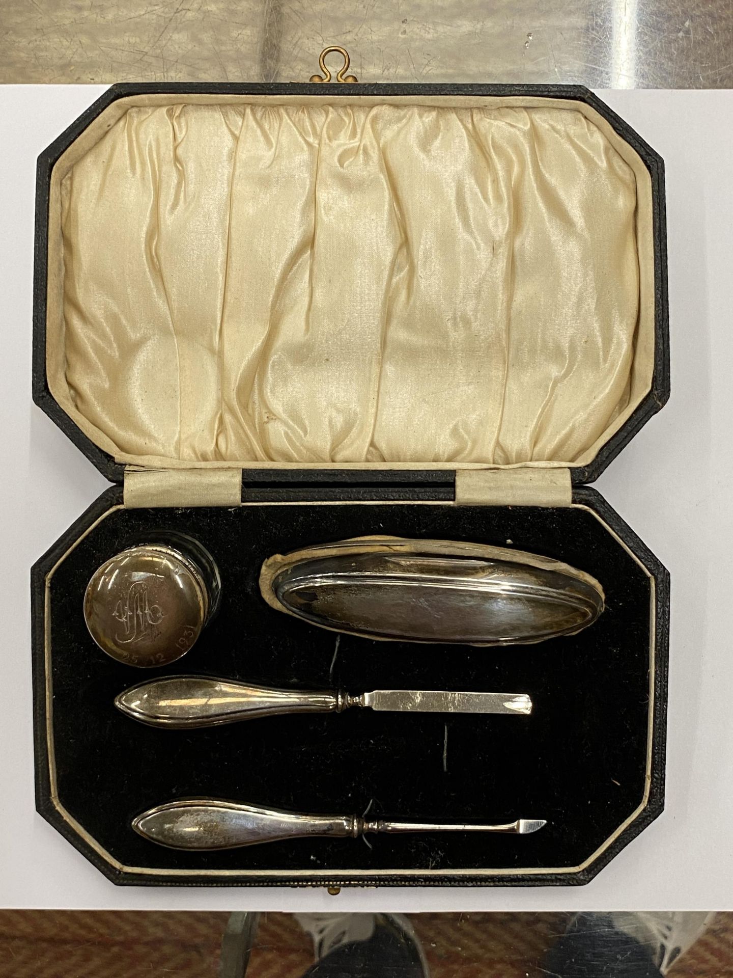 A CASED VINTAGE HALLMARKED SILVER BACKED MANICURE SET