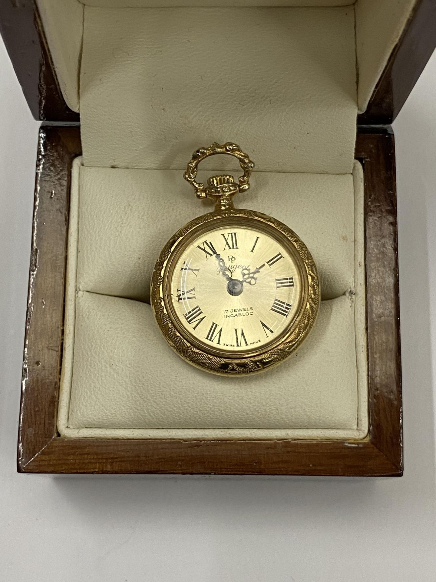 A MINIATURE GILT DESIGN POCKET WATCH, BOXED