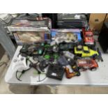 A LARGE ASSORTMENT OF REMOTE CONTROL CARS WITH CONTROLLERS