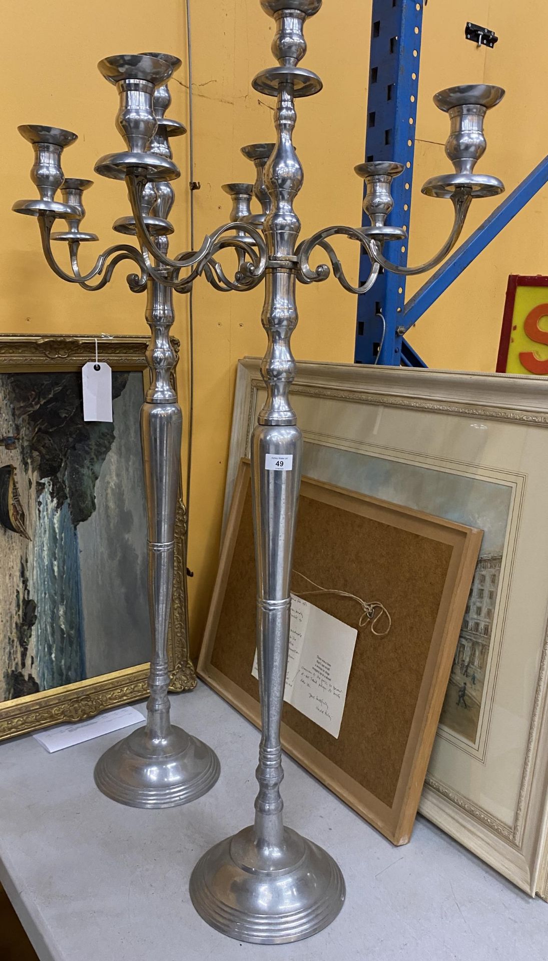 A LARGE PAIR OF CHROME EFFECT FLOOR STANDING CANDLEABRA