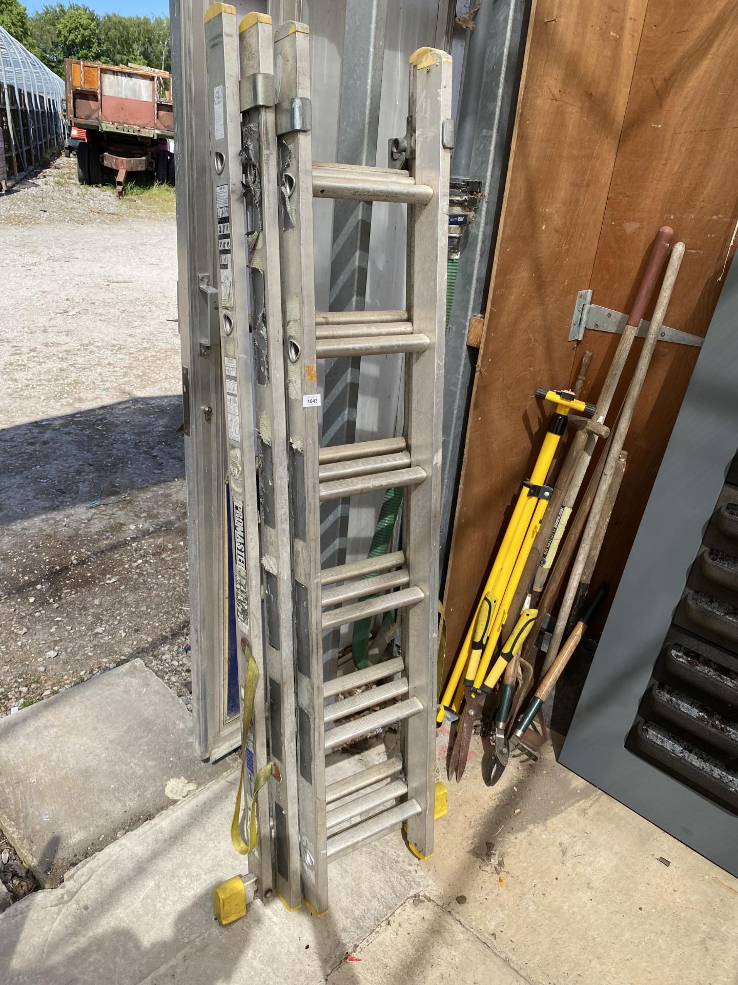 A THREE SECTION 18 RUNG ADJUSTABLE ALUMINIUM LADDER