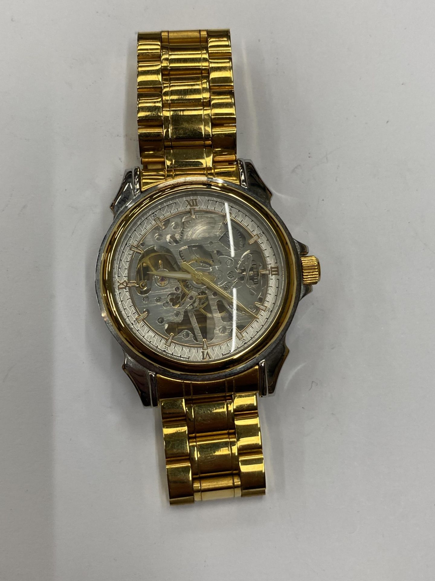 A GENTS SKELETON WATCH, WORKING WHEN CATALOGUED BUT NO WARRANTIES GIVEN