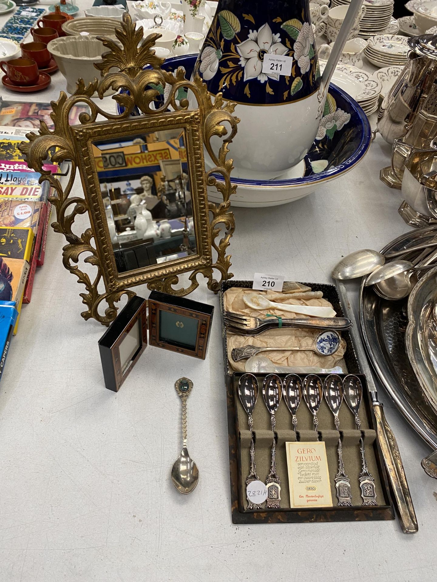 A BRASS MIRROR WITH BEVELLED GLASS, WOOD PICTURE FRAME, SPOON SET, KNIFE SHARPENER, ETC