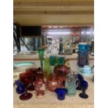 A COLLECTION OF COLOURED GLASSWARE TO INCLUDE VICTORIAN EYE BATHS, A DECANTER, VASES, GLASSES, ETC