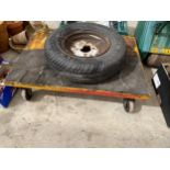 A METAL FOUR WHEELED WORKSHOP TROLLEY AND A SPARE WHEEL