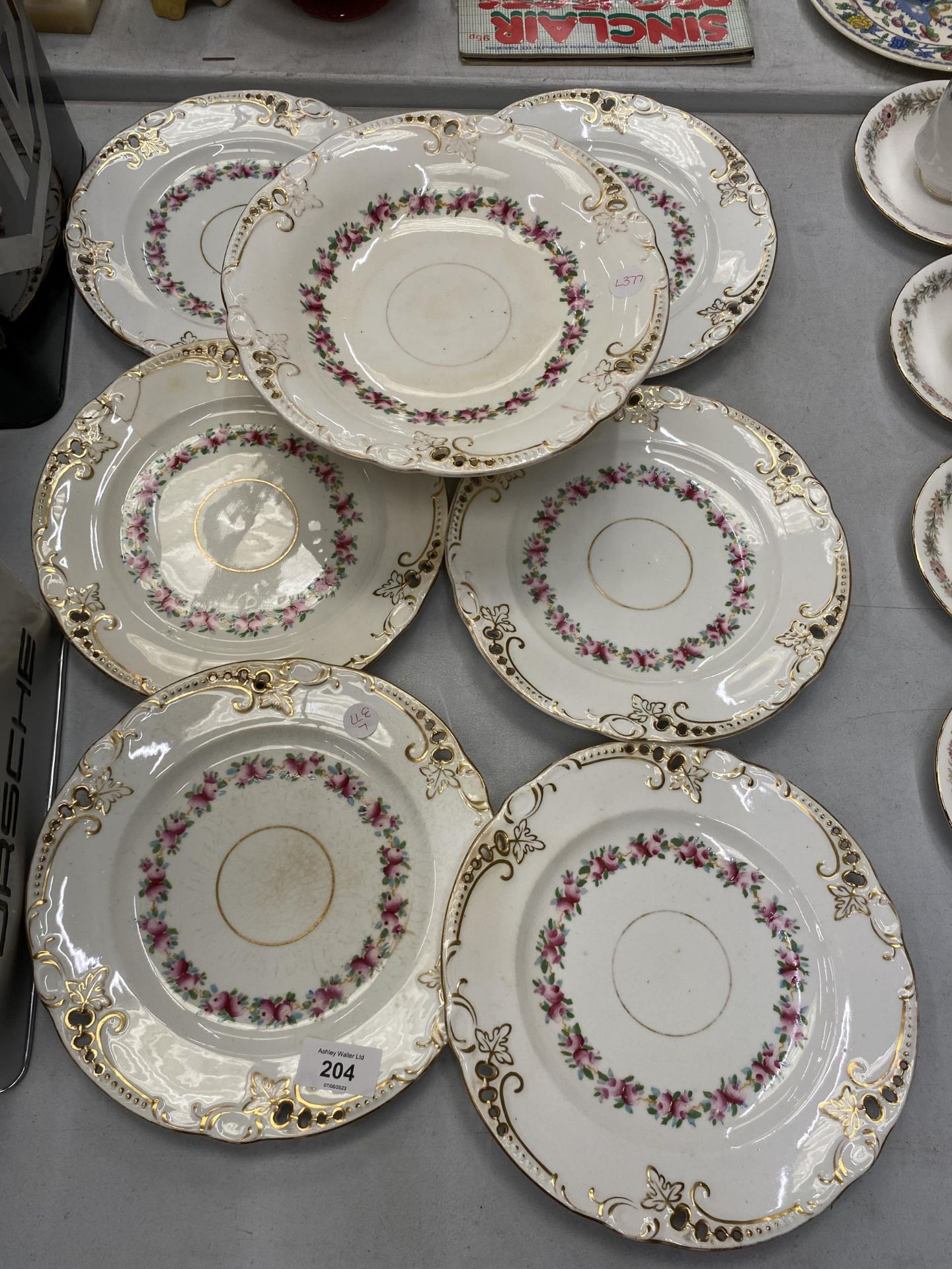 A SET OF SIX VICTORIAN PORCELAIN PLATES AND A COMPORT, HANDPAINTED WITH PIERCED EDGES
