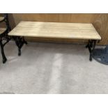 A WOODEN SLATTED TABLE WITH CAST IRON BENCH ENDS