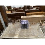 A LARGE QUANTITY OF ASSORTED GLASS WARE TO INCLUDE CHAMPAGNE FLUTES, WHISKET TUMBLERS AND WINE