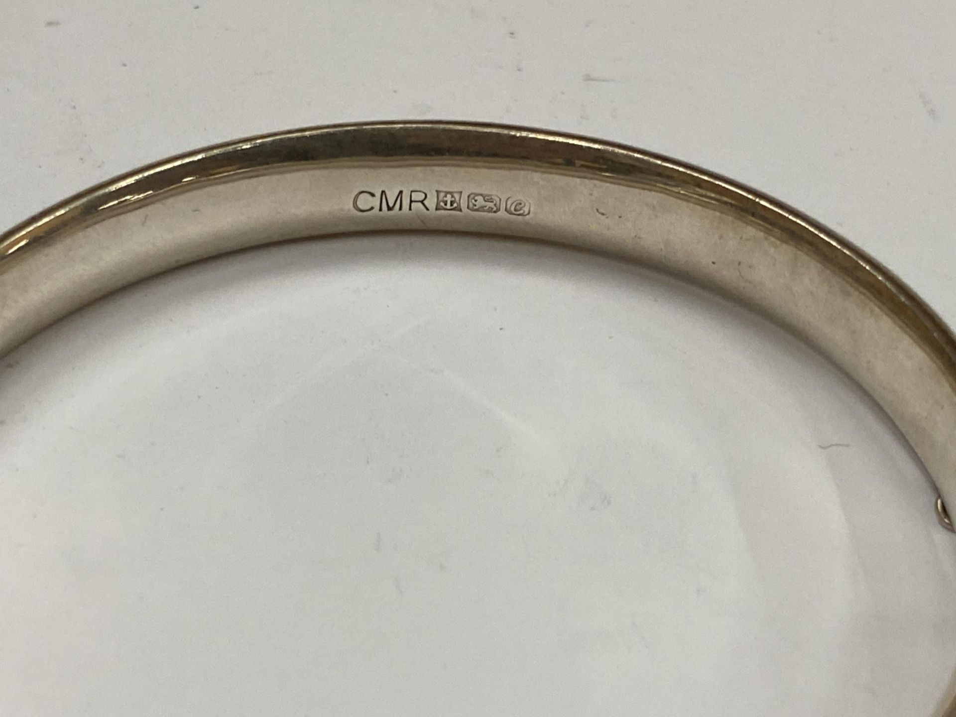 TWO SILVER BRACELETS TO INCLUDE HALLMARKED CHILD'S BANGLE AND OTHER DECORATIVE EXAMPLE - Image 2 of 3
