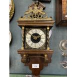 A VINTAGE MAHOGANY CASED WALL CLOCK WITH BRASS DECORATION - LACKING KEY, AND WEIGHTS