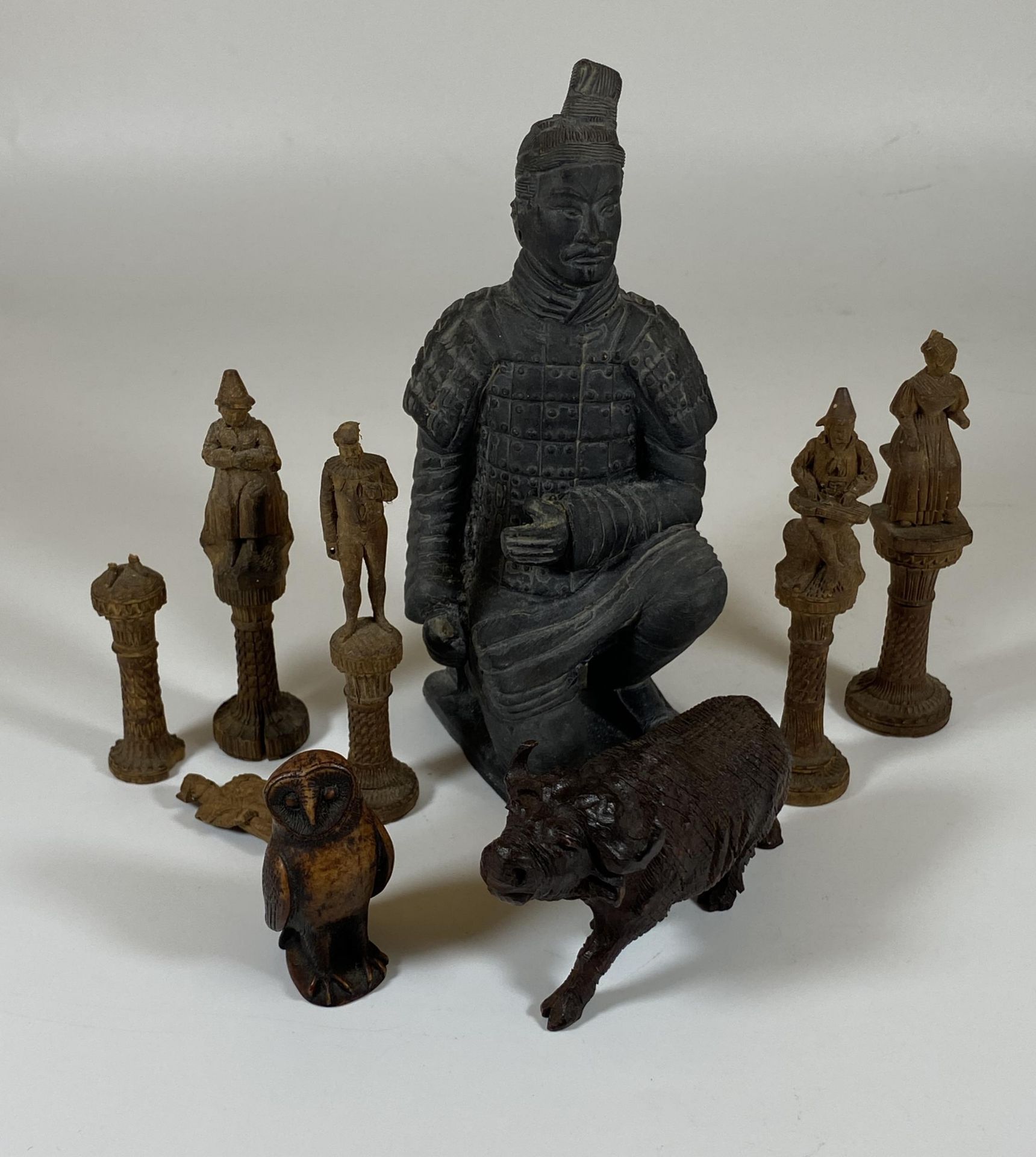 A CHINESE XIAN POTTERY WARRIOR FIGURE TOGETHER WITH FIVE CARVED ORIENTAL CHESS PIECES & A CARVED