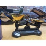 A SET OF VINTAGE CAST WEIGHING SCALES WITH BRASS PANS