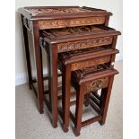 A SET OF FOUR CHINESE CARVED HARDWOOD NEST OF TABLES, THE SMALLEST WITH SINGLE DRAWER