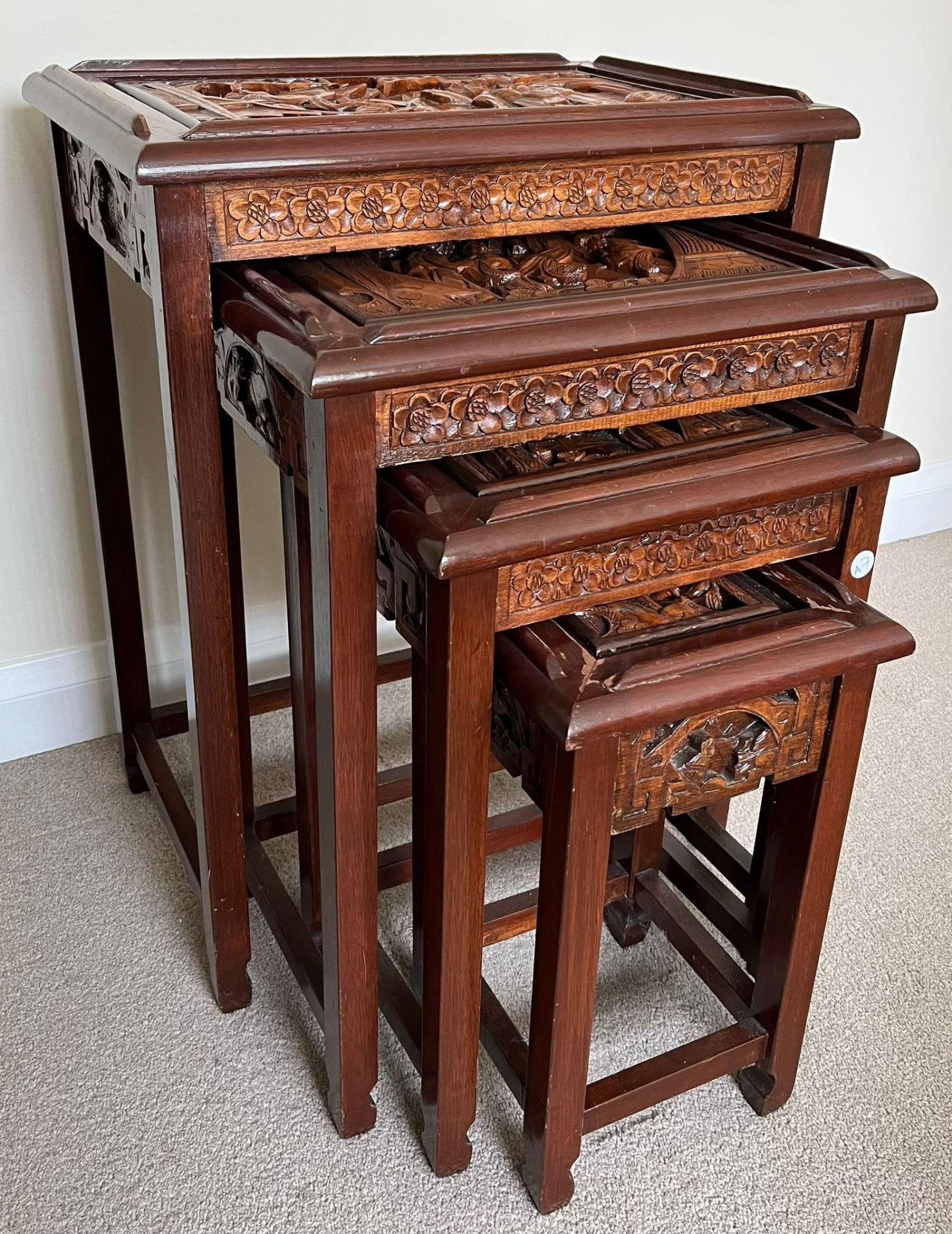 A SET OF FOUR CHINESE CARVED HARDWOOD NEST OF TABLES, THE SMALLEST WITH SINGLE DRAWER