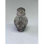 A SMALLGLASS AND METAL PERFUME BOTTLE