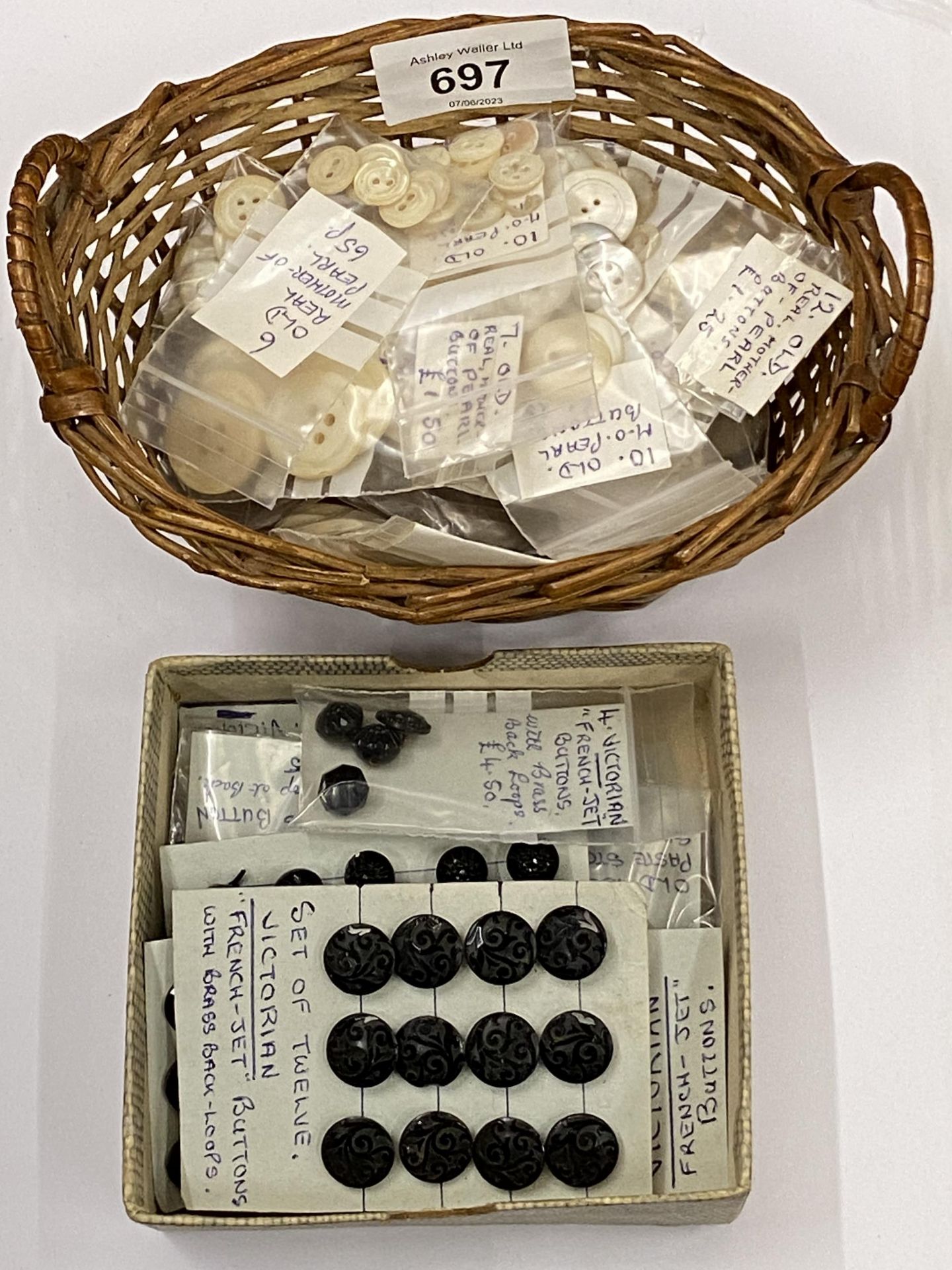 A COLLECTION OF VICTORIAN FRENCH JET BUTTONS AND SMALL BASKET OF OLD PEARL STYLE BUTTONS